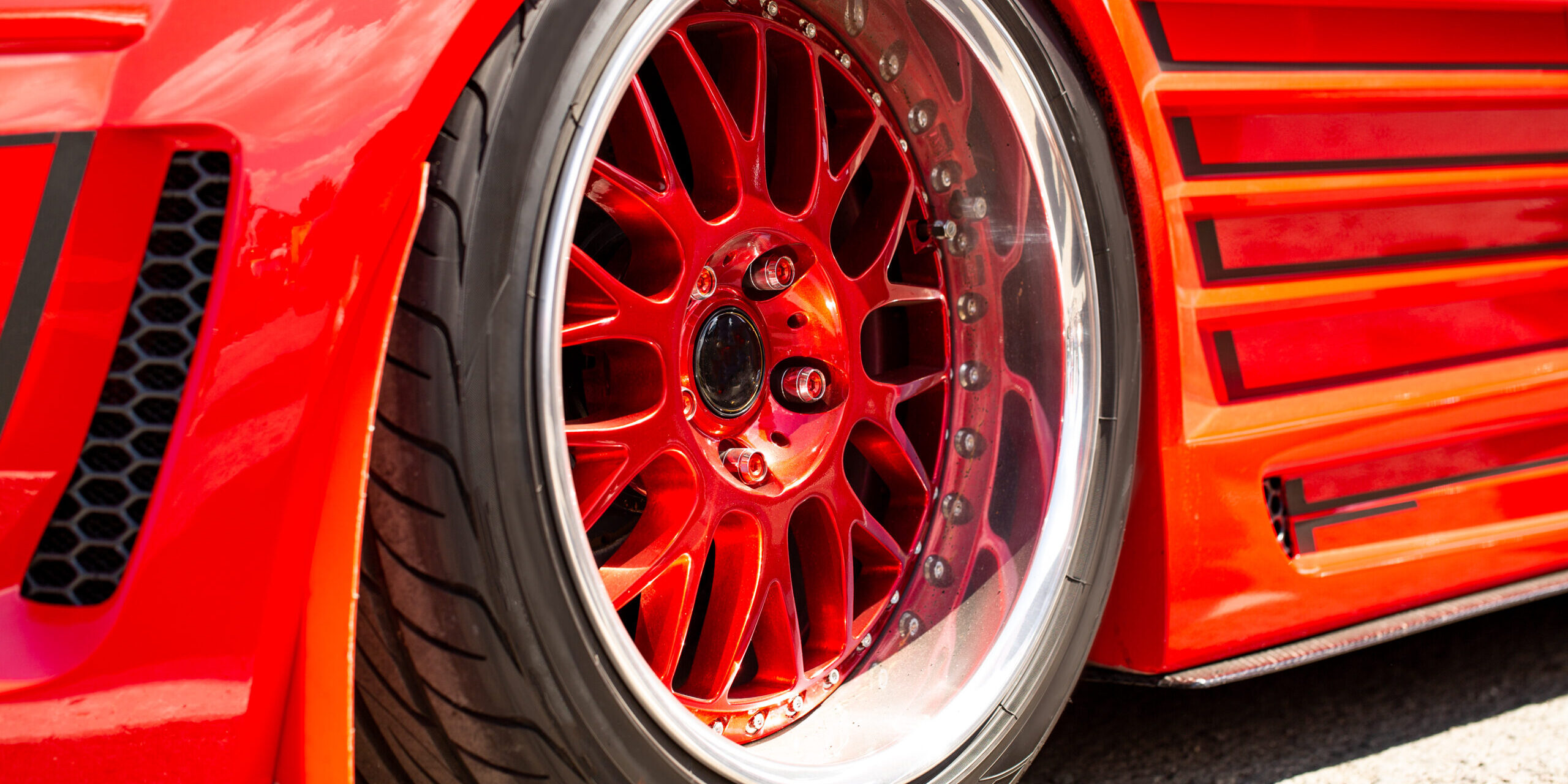 Red sports tuned car rear view of the wheel, close-up .